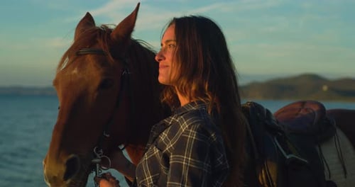 Close Up Portrait of a Beautiful Woman With her Horse on Seaside Beach at Sunset. Professional F