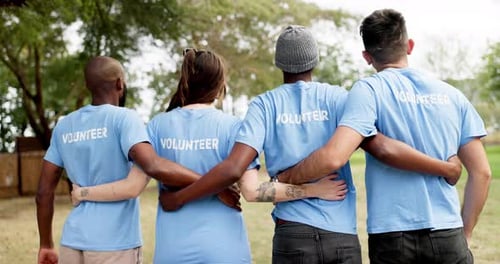 Volunteers Standing Together in a Grassy Area