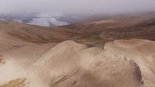 Mountain Landscape Bathed in Golden Sunlight Towering Peaks Piercing Cloud Layer Revealing Serene