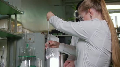 A Women Conduct Chemical Experiments in Medical Laboratory