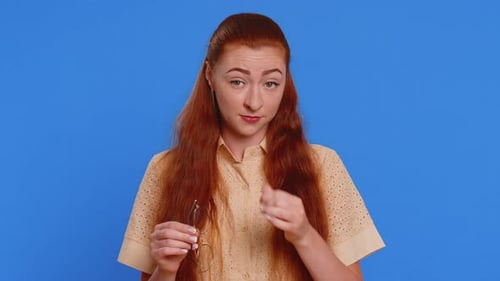 Woman Taking Off Glasses and Rubbing Eyes