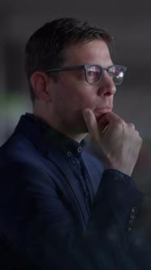 Man Wearing Glasses Thinking With Hand to Chin