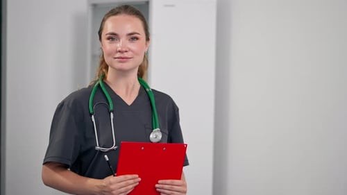 in a Modern Clinic in a Small Therapist s Office a Young Girl Doctor with a Red Folder Test Results