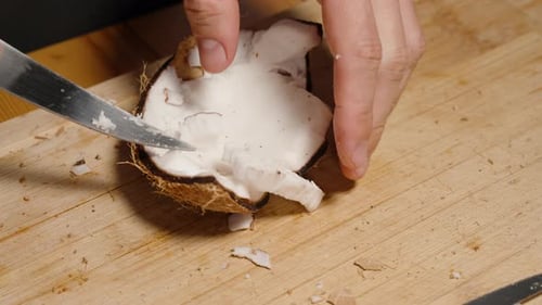 Cutting Coconut Flesh from a Cracked Coconut Shell