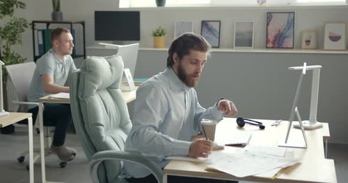 Focused Employee Sitting at Workplace in the Office