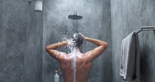 Man Washing in Shower Back View Man Soaping Foaming Hair Washing Hair Standing Under Shower in Grey