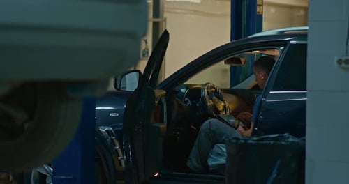 Mechanic Using Tablet Pc at the Repair Garage Service