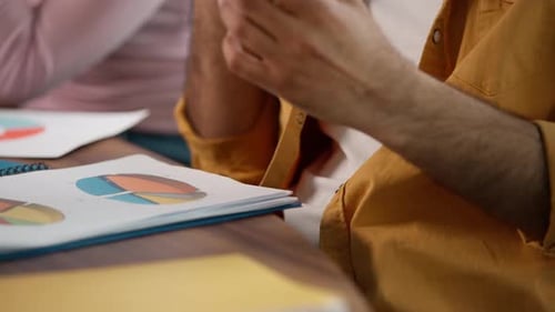 Man talking on phone with charts at work