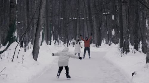 Happy Parents and Their Son are Enjoying a Day at the Ice Rink They Greet Each Other with Warm