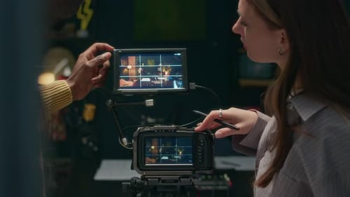 Female Technician Talking to Podcast Host when Setting Camera before Recording