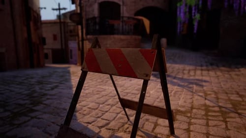 A Red and White Sign Sitting on the Side of a Road