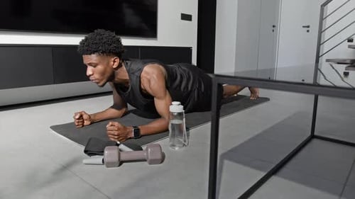Man Planking on Exercise Mat in Living Room