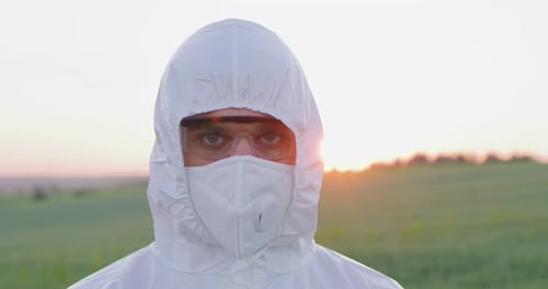 Portrait of Caucasian Farmer Man Wearing Protective Equipment Looking at the Camera at the Field