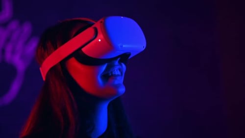 Woman Using Virtual Reality Headset with Blue and Red Lights