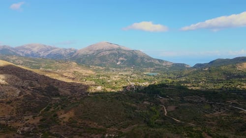 Shadows passing over greek countryside with roads, farms mountain landscape