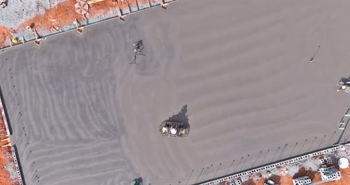 Polishing and Leveling the Cement Screed Mortar Floor on a Construction Site is a Process That