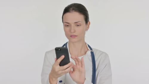 Doctor Using Smartphone in White Room