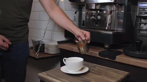 Barista Pouring Espresso Into Cup at Cafe
