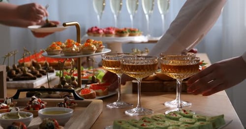 Buffet menu. Woman and man taking appetizers from table indoors, closeup