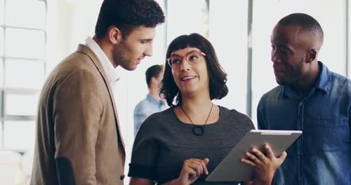 Business Team Collaborates on Tablet in Office