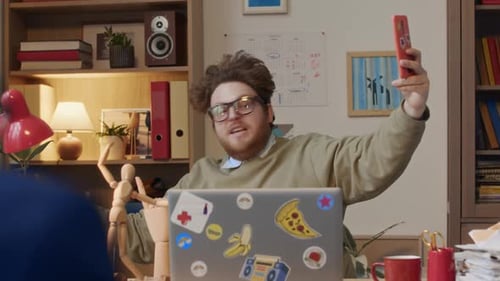 Office Clown Filming Social Media Reel at Desk and Colleague Trying to Work