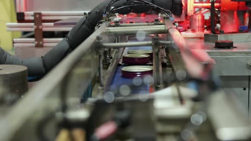 Industrial Conveyor Belt Moving Jar Lids in Factory