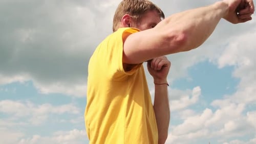 Man Boxing Outdoors on Sunny Day