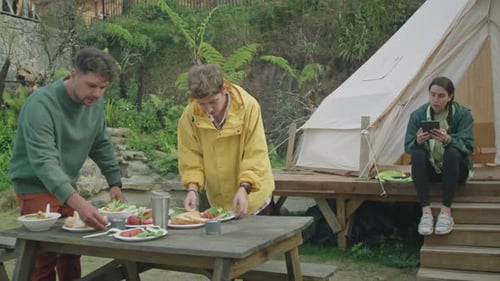 Friends Eating Food Outdoors in a Rural Setting