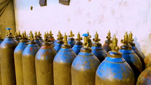 Stock of empty blue oxygen cylinders for industry. Liquified oxygen production. Close up.