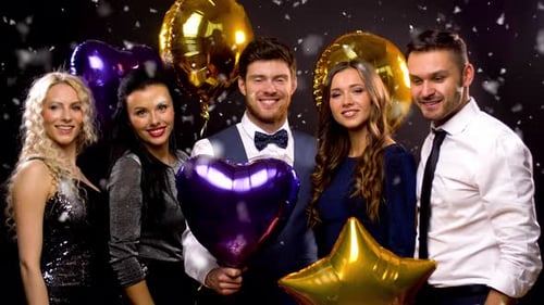 Group Celebrates at Party with Balloons and Confetti