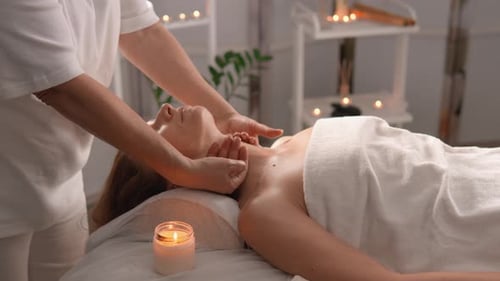 Woman Getting Relaxing Massage in Spa Setting