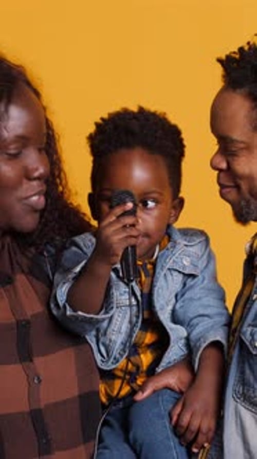 Happy Family Singing into Microphone Together