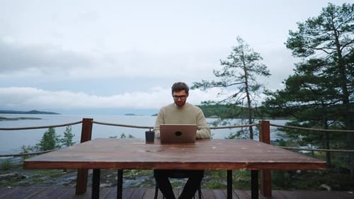 Freelancer Working With Laptop Sitting On Terrace With Beautiful Natural Landscape Dolly Shot