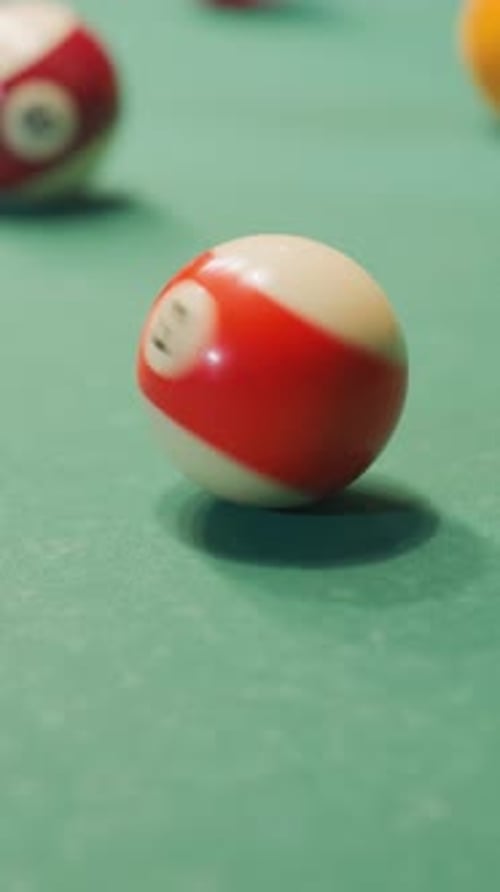Close Up of Hand Rolling Ball on Green Pool Table