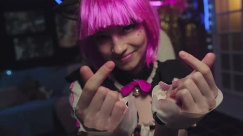 Woman in Costume Posing with Heart Gesture Indoors