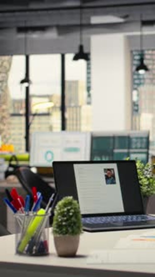 Vertical Video Empty Office with a Laptop Showcasing CV Candidate Before Job Interview