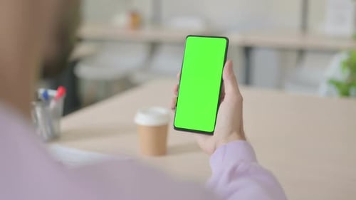 Rear View of Man Looking at Smartphone with Green Chroma Screen