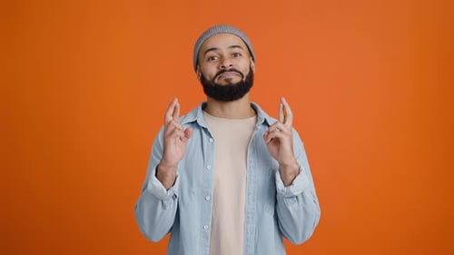 Young African American Man Makes Wish Crossing Fingers