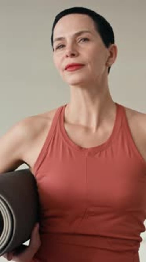 Confident Woman Smiling With Yoga Mat