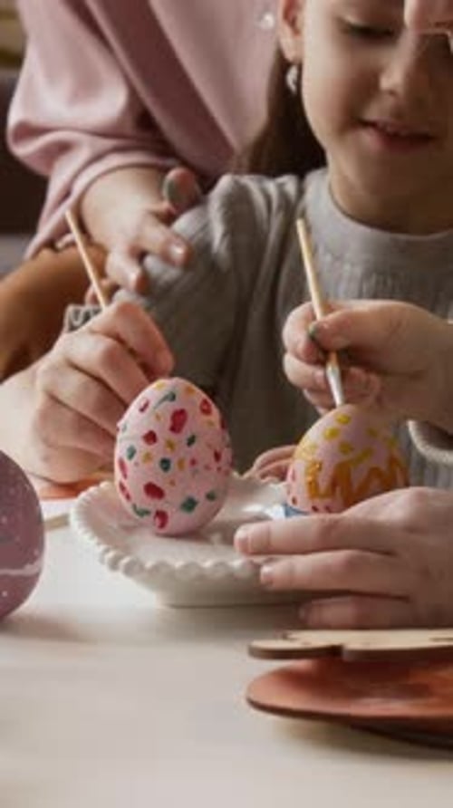 Vertical of Creative Girls Decorating Eggs with Gouache Paint for Easter Holiday