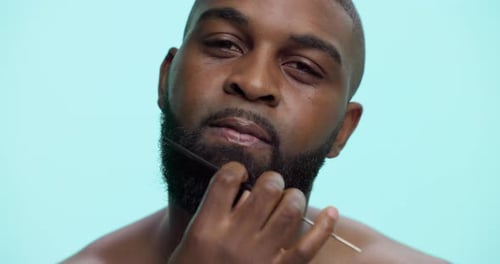Face, styling and man with beard, comb and tangle prevention with tool, smile