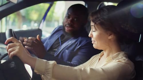 Woman Driving Car with Passenger Talking