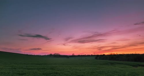 Empty Field With Cresent Moon Time Lapse At Sunset