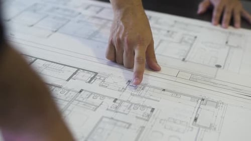 An architect traces the outline of a house plan, guiding us through the blueprint of a dream home wi