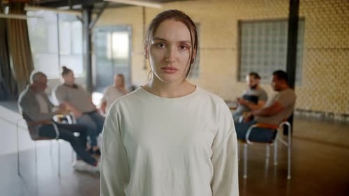 Young Woman Standing with Arms Crossed in Therapeutic Center