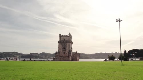 Drone pan of Belém Tower along the Tagus River waterfront in Lisbon, Portugal