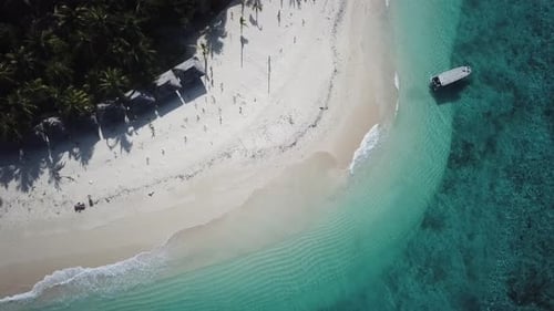 Serenity island exotic paradise destination bird view descending over top of tourist boat on turquoi