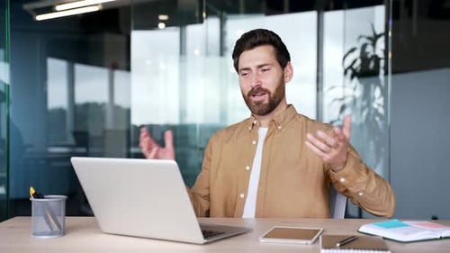 Smiling Man Attending Online Meeting At Modern Workplace
