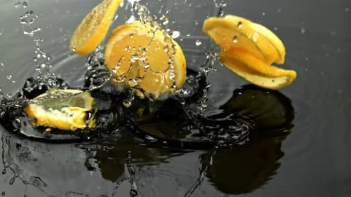 Lemon Slices Fall on a Wet Surface Filmed on a Highspeed Camera at 1000 Fps