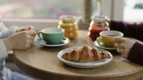 Two People Sit in Cafe Drinking Hot Fruit Vitamin Tea From Cups Pouring Red